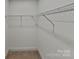 A walk-in closet with wire shelving and neutral carpeting provides efficient storage at 3608 Shadowcrest Dr, Concord, NC 28027
