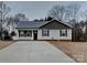 Charming single-story home with gray siding, a paved driveway, and a well-maintained front yard at 3608 Shadowcrest Dr, Concord, NC 28027