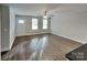 Bright living room with wood-look floors, natural light, and a ceiling fan at 3608 Shadowcrest Dr, Concord, NC 28027