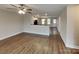 Open living space with wood-look floors, modern lighting, and seamless flow to the kitchen at 3608 Shadowcrest Dr, Concord, NC 28027