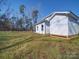 View of the backyard with a lush lawn and a backdrop of trees at 502 Geneva Cir, Gastonia, NC 28056
