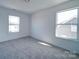 Bedroom with carpet and two bright windows at 502 Geneva Cir, Gastonia, NC 28056