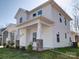 This is a charming two-story home featuring a welcoming front porch with stone accents and white pillars at 502 Geneva Cir, Gastonia, NC 28056