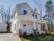 Charming two-story home featuring a welcoming front porch with stone accents and white pillars at 502 Geneva Cir, Gastonia, NC 28056