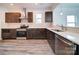 Modern kitchen with dark wood cabinets, white countertops, stainless steel appliances, and sleek backsplash tiles at 502 Geneva Cir, Gastonia, NC 28056