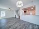 Open-concept living room boasts modern gray flooring, white walls, and a view into a stylish kitchen at 502 Geneva Cir, Gastonia, NC 28056