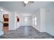 Open-concept living space boasts gray floors, white walls, and a view into a kitchen with dark wood cabinetry at 502 Geneva Cir, Gastonia, NC 28056