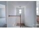Bright stairwell features neutral carpeting, white walls, and natural light from the window at 502 Geneva Cir, Gastonia, NC 28056