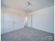Carpeted bedroom featuring closet space, neutral walls and doorway view to the next room at 554 Geneva Cir, Gastonia, NC 28056