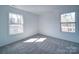 This carpeted bedroom is lit by two windows providing natural light to the room at 554 Geneva Cir, Gastonia, NC 28056