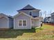 Exterior showing a home with light-grey siding, a green lawn, and bright-white trim on a sunny day at 554 Geneva Cir, Gastonia, NC 28056
