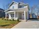 Charming two-story home featuring a covered front porch and separate storage shed at 554 Geneva Cir, Gastonia, NC 28056