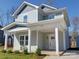 Charming two-story home featuring a covered front porch with white columns and light gray siding at 554 Geneva Cir, Gastonia, NC 28056