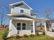 Charming two-story home featuring a covered front porch and a well-maintained lawn at 554 Geneva Cir, Gastonia, NC 28056