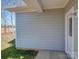 Shows a house with light-grey horizontal siding, white trim, green grass and a partially visible yard and fence at 554 Geneva Cir, Gastonia, NC 28056