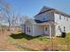 View of a two-story home with light-grey siding, a green lawn, and bright-white trim on a sunny day at 554 Geneva Cir, Gastonia, NC 28056