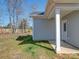 A view of the home with light-grey horizontal siding, white trim, green grass and a partially visible yard and fence at 554 Geneva Cir, Gastonia, NC 28056
