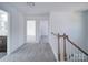 Hallway with carpeted floors, white walls, and light-colored banister offers access to the bedrooms at 554 Geneva Cir, Gastonia, NC 28056