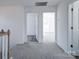 Upstairs hallway featuring access to two bedrooms, each with a light interior at 554 Geneva Cir, Gastonia, NC 28056