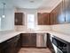 The kitchen offers stainless steel appliances, dark cabinets, light countertops, and light backsplash at 554 Geneva Cir, Gastonia, NC 28056