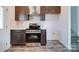 This kitchen features stainless steel appliances, dark cabinets, light countertops, and wood-look floors at 554 Geneva Cir, Gastonia, NC 28056