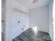 Functional laundry room with vinyl flooring, neutral colored walls and upper shelf at 554 Geneva Cir, Gastonia, NC 28056