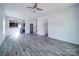 Open-concept living room featuring modern flooring that leads into the kitchen and stairway at 554 Geneva Cir, Gastonia, NC 28056