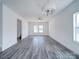 A spacious living room is well lit by natural light and a modern light fixture at 554 Geneva Cir, Gastonia, NC 28056