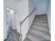 Carpeted staircase with light-colored banister leads to the upper level of the home at 554 Geneva Cir, Gastonia, NC 28056