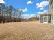 Expansive backyard featuring a screened porch, providing a serene outdoor living space at 6351 Trinity Crossing Cir, Kannapolis, NC 28081