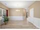 Bright dining room featuring wood-look floors, modern chandelier, and white wainscoting at 6351 Trinity Crossing Cir, Kannapolis, NC 28081