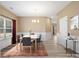 Bright dining room featuring wood-look floors, modern chandelier, and a table set for six at 6351 Trinity Crossing Cir, Kannapolis, NC 28081
