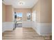 Bright entryway with white wainscoting, hardwood floors, and access to other rooms at 6351 Trinity Crossing Cir, Kannapolis, NC 28081