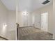 Bright hallway leads to various rooms, with carpeted flooring, neutral walls, and white doors at 6351 Trinity Crossing Cir, Kannapolis, NC 28081