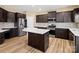 Updated kitchen featuring stainless steel appliances, dark cabinets, and a kitchen island at 6351 Trinity Crossing Cir, Kannapolis, NC 28081