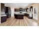 Modern kitchen featuring dark cabinets, stainless steel appliances, and a central island at 6351 Trinity Crossing Cir, Kannapolis, NC 28081