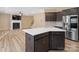 Open kitchen with stainless steel appliances and a center island seamlessly connects to the living room at 6351 Trinity Crossing Cir, Kannapolis, NC 28081