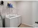 Laundry room featuring a modern washer and dryer, wire shelving, and tiled flooring at 6351 Trinity Crossing Cir, Kannapolis, NC 28081