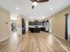 Open-concept living room and kitchen with recessed lights and wood-look floors at 6351 Trinity Crossing Cir, Kannapolis, NC 28081