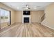 Open living room featuring a fireplace, ceiling fan, and wood-look floors at 6351 Trinity Crossing Cir, Kannapolis, NC 28081