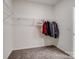 Walk-in closet with carpet flooring, wire shelving, and hanging clothes on hangers at 6351 Trinity Crossing Cir, Kannapolis, NC 28081