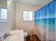 Clean bathroom with a shower/tub combo and beach-themed curtain at 720 Pleasant Ave, Kannapolis, NC 28081