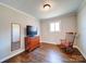 Bedroom with hardwood floors, a rocking chair, and a dresser at 720 Pleasant Ave, Kannapolis, NC 28081