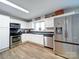 Kitchen features white cabinets and stainless steel appliances at 720 Pleasant Ave, Kannapolis, NC 28081