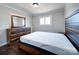 Main bedroom with wood-toned dresser and a comfortable bed at 720 Pleasant Ave, Kannapolis, NC 28081