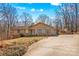 Ranch style home with a spacious driveway and mature trees at 906 Harmony Dr, Statesville, NC 28677