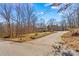 House exterior showcasing a long driveway and wooded surroundings at 906 Harmony Dr, Statesville, NC 28677