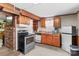 Small galley kitchen with wood cabinets and standard appliances at 906 Harmony Dr, Statesville, NC 28677