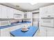 White kitchen with blue countertops and built-in appliances at 906 Harmony Dr, Statesville, NC 28677