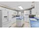 Galley kitchen with white cabinets and blue countertops at 906 Harmony Dr, Statesville, NC 28677